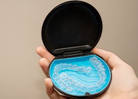 Woman putting Invisalign into case 