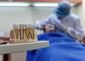 dentist performing dental implant surgery  