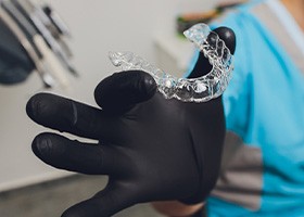 Dental team holding Invisalign tray