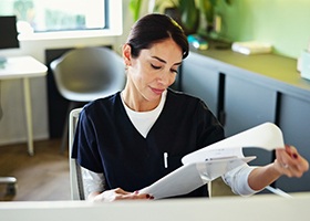 Team member looking over dental insurance form 