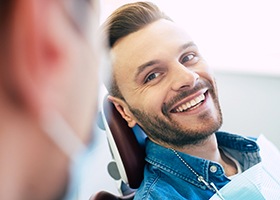 Male dental patient speaking to cosmetic dentist