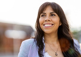 Middle-aged woman smiling outside