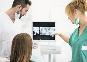 Dentist and team member looking at dental x-rays