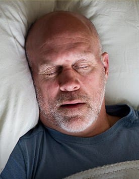 Man sleeping soundly in bed