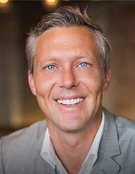 Man in gray suit smiling