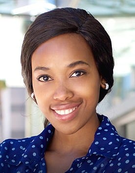 Young woman in dotted blouse smiling