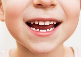 Close up of child smiling after fluoride treatment in Oklahoma City
