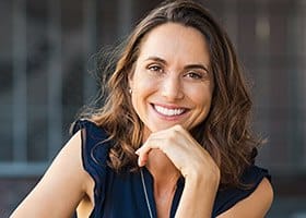 Woman smiling in sleeveless blue blouse