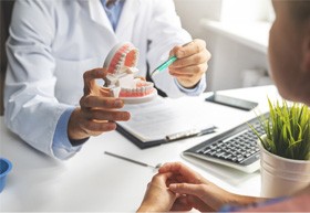 patient talking to dentist about implant denture 