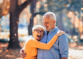 older couple hugging outdoors