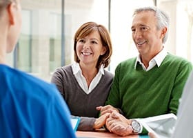 Older man and woman during dental treatment consultation