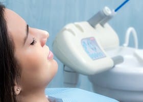 Woman with eyes closed in dental chair