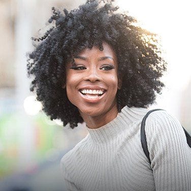 Young woman in turtleneck sweater smiling