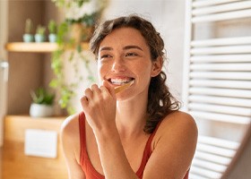 young woman brushing her teeth