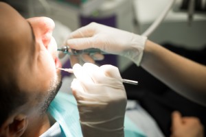 man relaxed during a regular checkup and oral cancer screening from his family dentist in oklahoma city