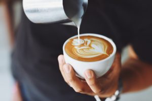 foamy cup of coffee with latte art  