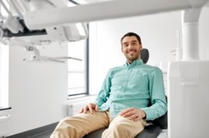 male patient smiling in dental chair 