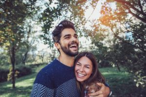 attractive couple smiling outdoors 