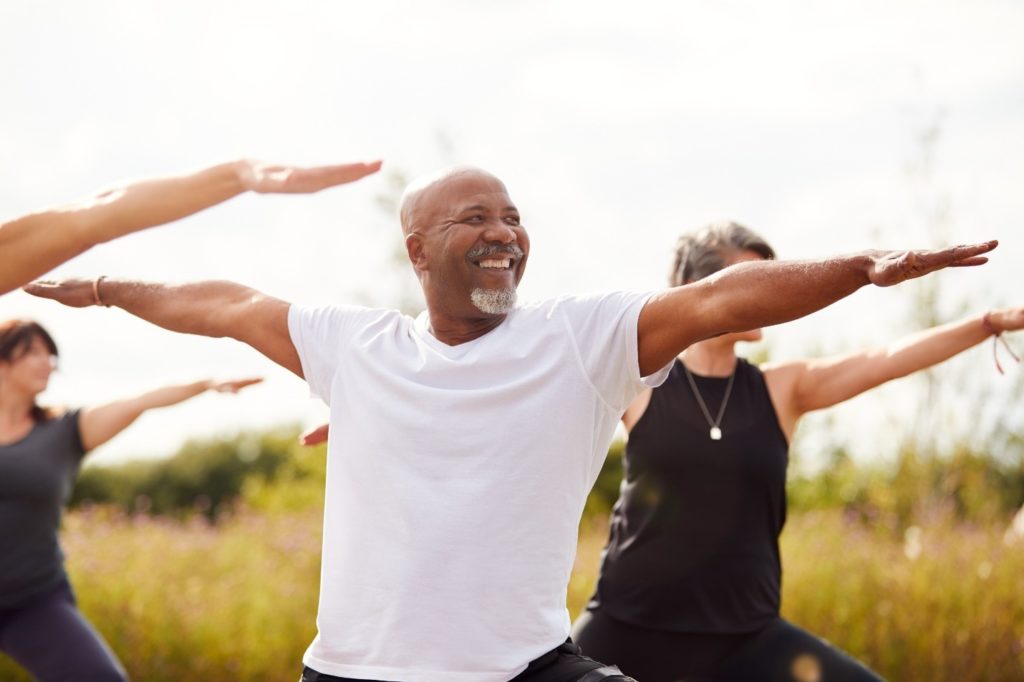 Man with healthy smile practicing yoga