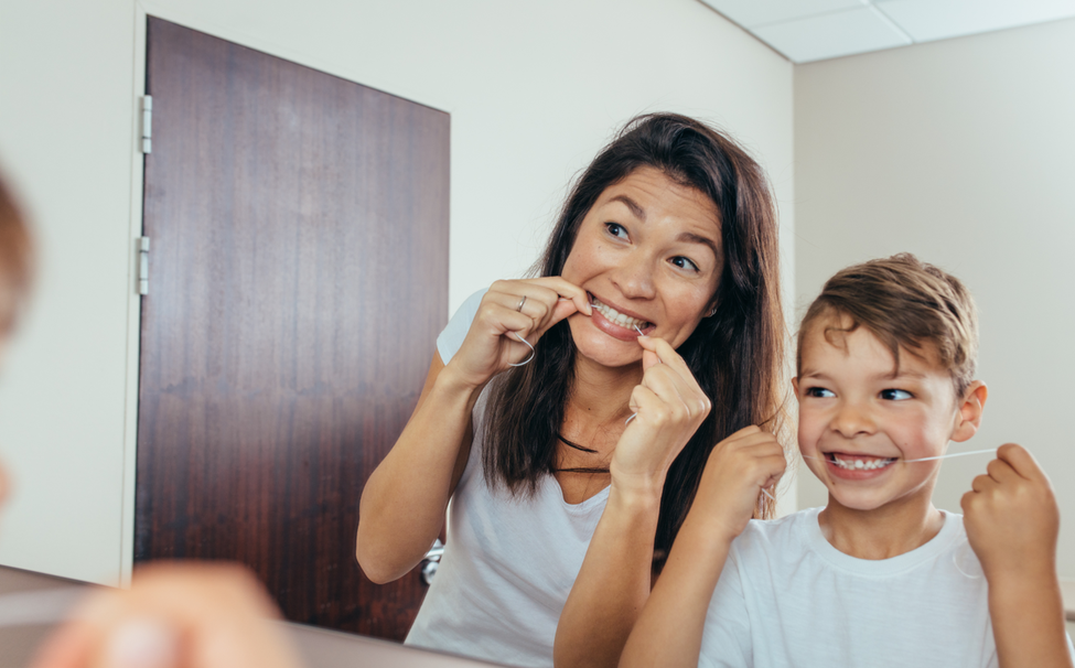 mother and son flossing together