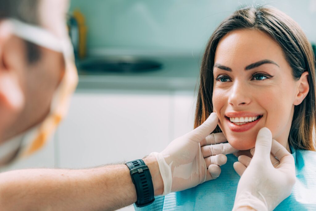 Dentist looking at smiling patient's teeth