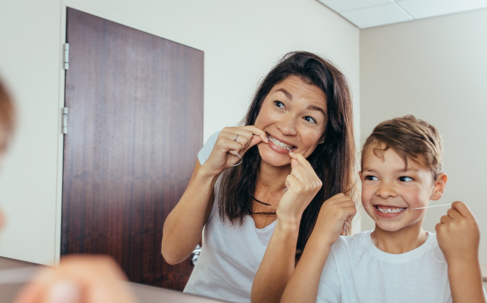 mother and son flossing together